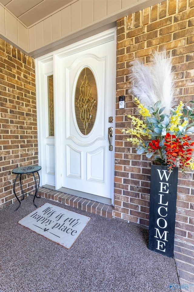 property entrance with brick siding