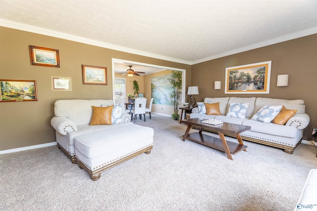 living area featuring carpet flooring, crown molding, and baseboards