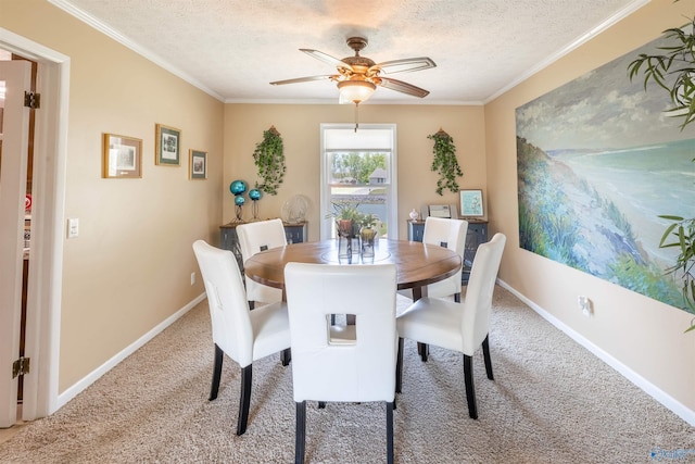 dining area with carpet floors, a textured ceiling, baseboards, and ornamental molding