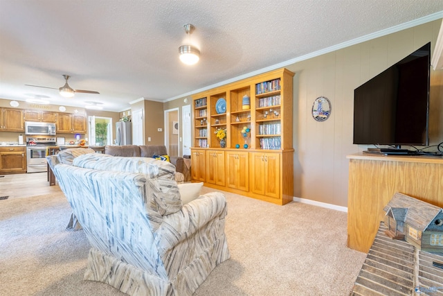 living area featuring crown molding, ceiling fan, light carpet, and a textured ceiling