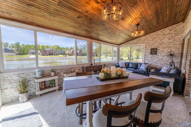 sunroom / solarium featuring a water view and a notable chandelier