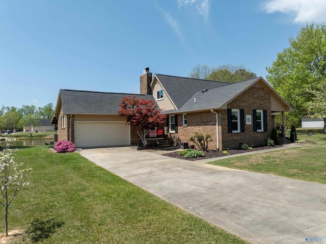 ranch-style home with brick siding, a garage, a front yard, and concrete driveway