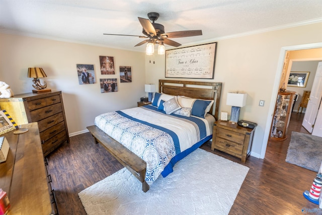 bedroom featuring crown molding, baseboards, a ceiling fan, and wood finished floors