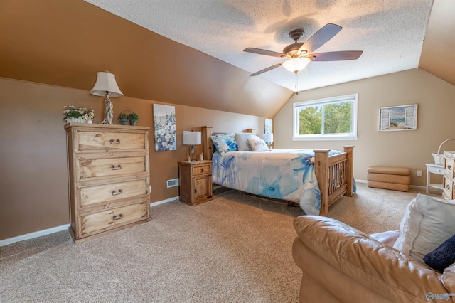 bedroom with a ceiling fan, a textured ceiling, vaulted ceiling, and light carpet
