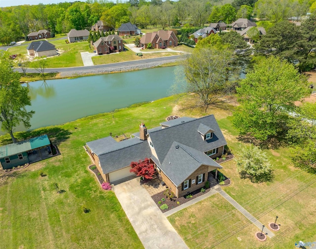 drone / aerial view featuring a residential view and a water view