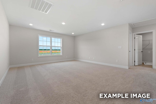 spare room with recessed lighting, visible vents, baseboards, and light colored carpet