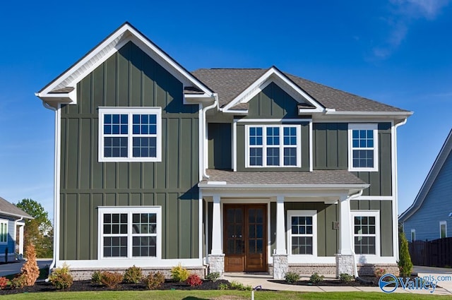 view of front of home with a front lawn and french doors