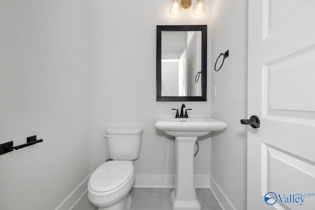 bathroom featuring tile patterned floors and toilet