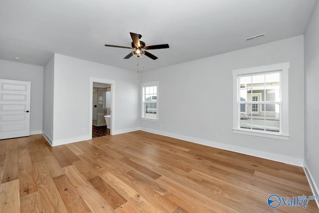 unfurnished bedroom with light wood-type flooring, connected bathroom, and ceiling fan