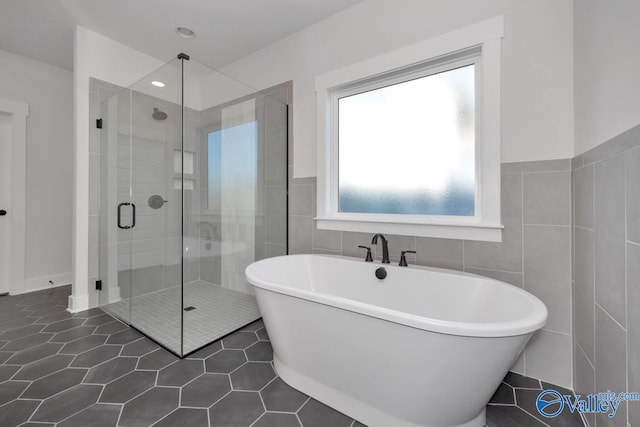 bathroom with plus walk in shower and tile walls