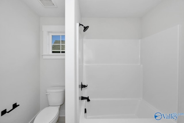 bathroom featuring a shower and toilet