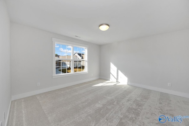 unfurnished room with light carpet