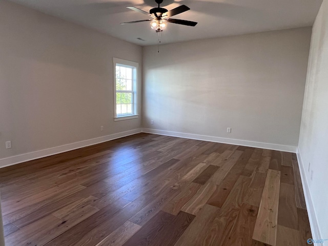 unfurnished room with dark hardwood / wood-style floors and ceiling fan