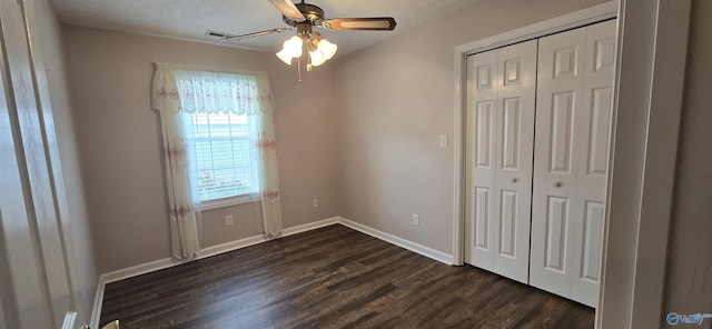 113 Sycamore Pl, Athens, AL 35611 - unfurnished bedroom with dark wood-type flooring, a closet, baseboards, and a ceiling fan