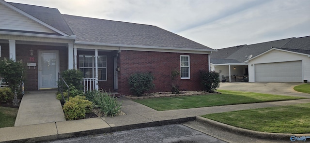 113 Sycamore Pl, Athens, AL 35611 - view of front of home featuring brick siding, covered porch, driveway, a front lawn, and a shingled roof
