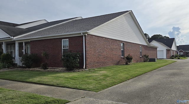 113 Sycamore Pl, Athens, AL 35611 - view of home's exterior with brick siding, central AC, a yard, roof with shingles, and a garage