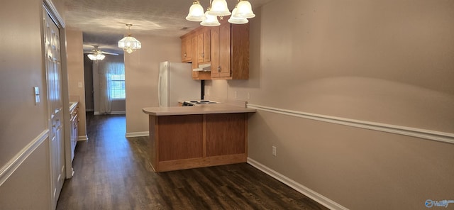 113 Sycamore Pl, Athens, AL 35611 - kitchen featuring freestanding refrigerator, a chandelier, dark wood-style floors, brown cabinetry, and a peninsula