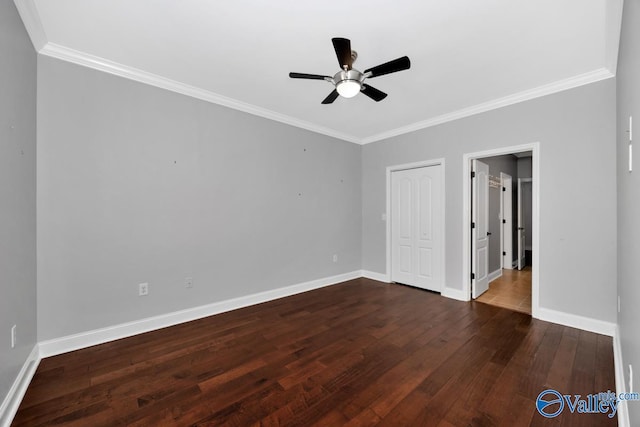 unfurnished bedroom featuring baseboards, dark wood finished floors, and crown molding