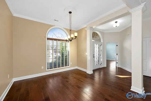 unfurnished dining area featuring dark wood-type flooring, visible vents, decorative columns, and an inviting chandelier