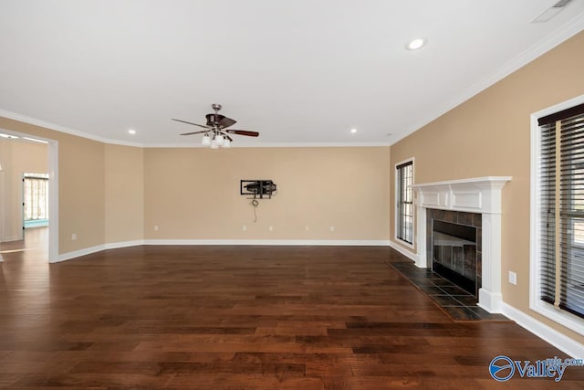 unfurnished living room with dark wood-style floors, ornamental molding, and a wealth of natural light