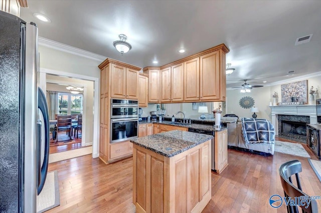 990 Chambers Rd, Double Springs, AL 35553 - kitchen with stainless steel appliances, a kitchen island, light wood-style flooring, crown molding, and light brown cabinets