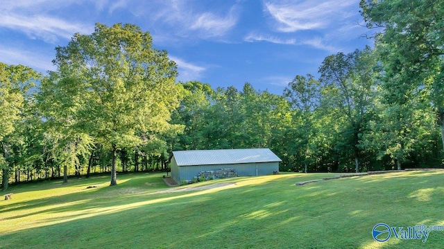990 Chambers Rd, Double Springs, AL 35553 - view of grassy yard featuring a pole building, an outdoor structure, view of golf course, and view of wooded area