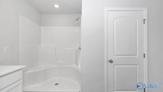 bathroom featuring vanity and a shower