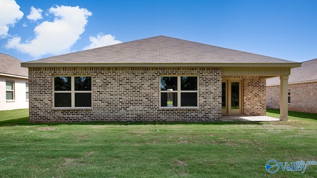 rear view of house with a patio area and a lawn