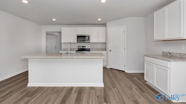 kitchen with white cabinetry, sink, a center island with sink, and appliances with stainless steel finishes