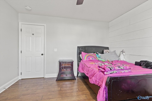 bedroom featuring wood-type flooring and ceiling fan