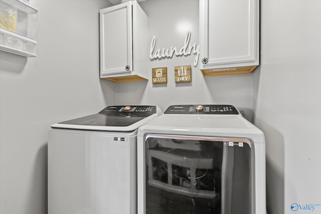 laundry area featuring washing machine and dryer and cabinets