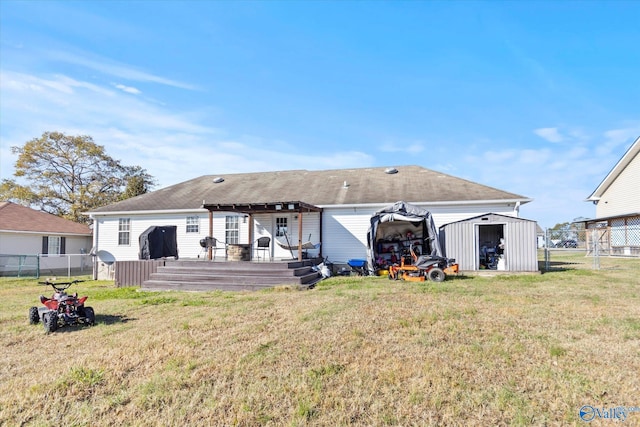 back of property featuring a storage unit, a yard, and a wooden deck