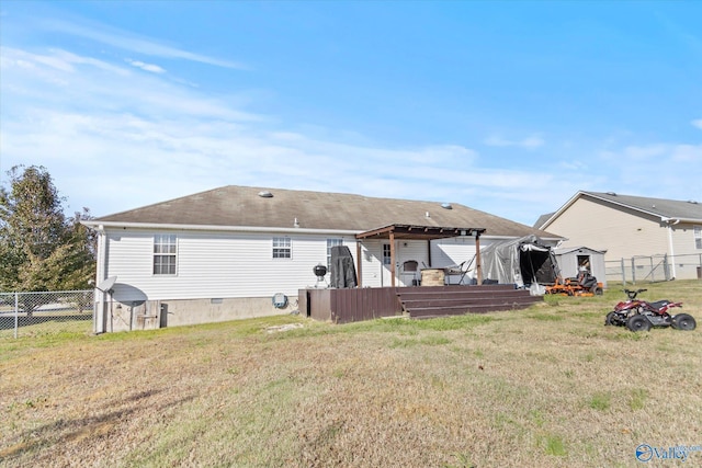 rear view of property with a lawn and a wooden deck