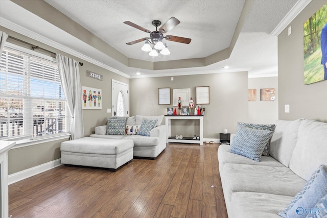 living room featuring a textured ceiling, ceiling fan, wood-type flooring, and crown molding