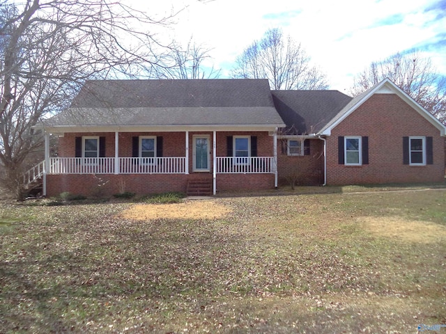 single story home with covered porch, brick siding, and a front lawn