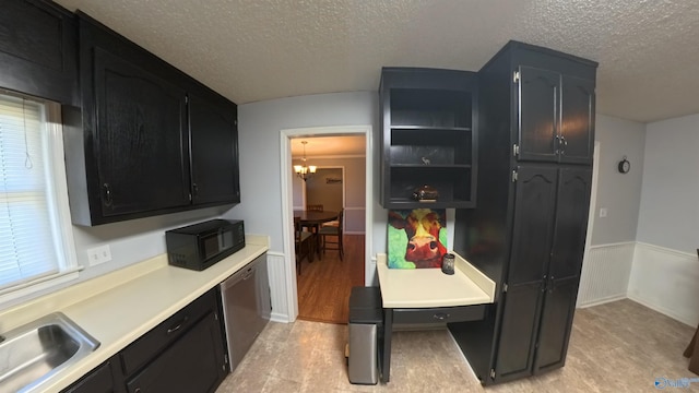 kitchen featuring black microwave, dark cabinets, a sink, light countertops, and dishwasher