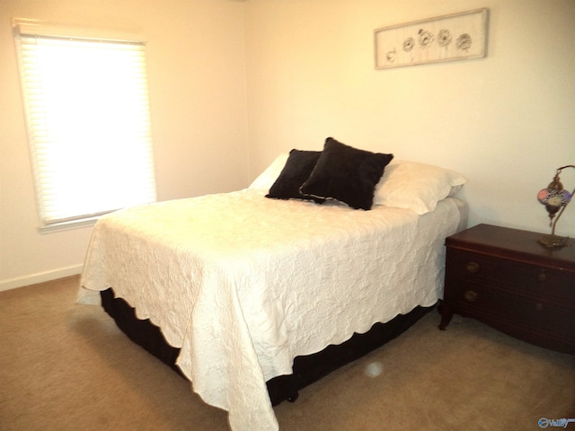 bedroom featuring carpet flooring and baseboards