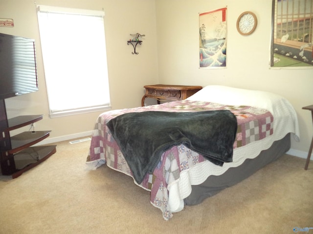 bedroom with carpet flooring, visible vents, and baseboards