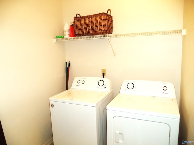 clothes washing area featuring laundry area and washer and clothes dryer