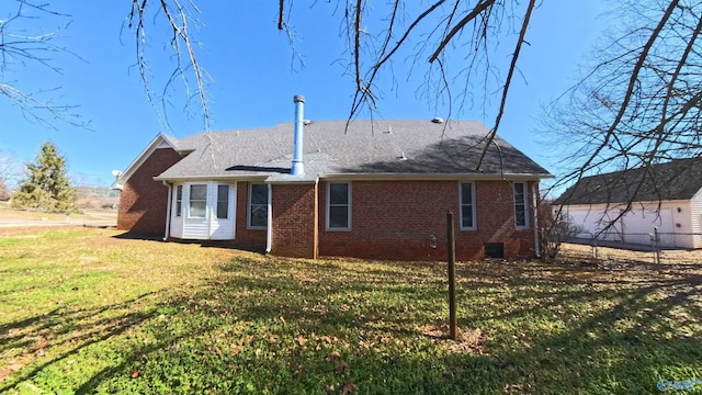 back of property featuring a yard, brick siding, and fence