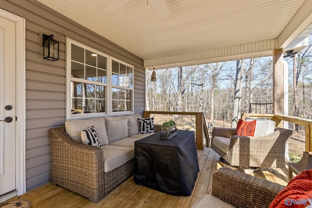 deck featuring outdoor lounge area and a ceiling fan