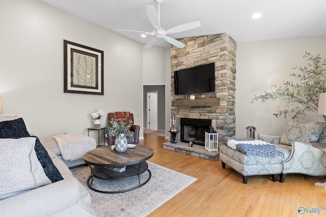 living area featuring a ceiling fan, recessed lighting, a fireplace, and wood finished floors