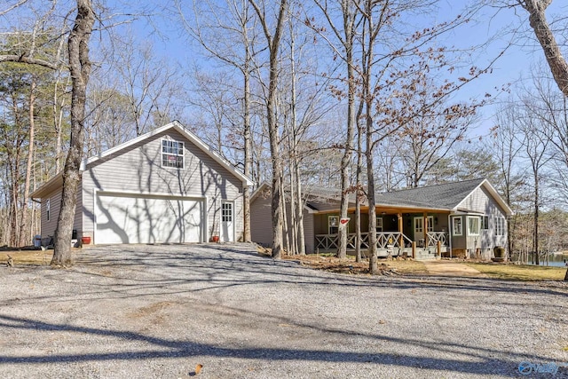 view of front of property with a garage, driveway, and a porch