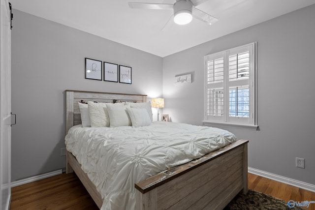 bedroom featuring dark wood-style floors, baseboards, and a ceiling fan