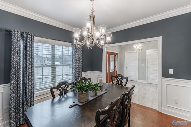 dining area featuring a wealth of natural light, a chandelier, and ornamental molding