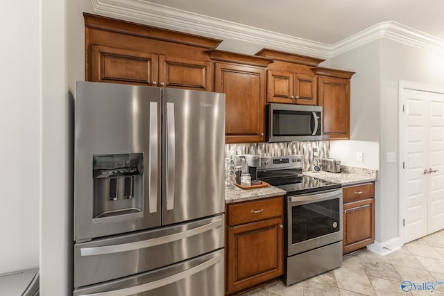 kitchen with backsplash, light stone counters, crown molding, and appliances with stainless steel finishes