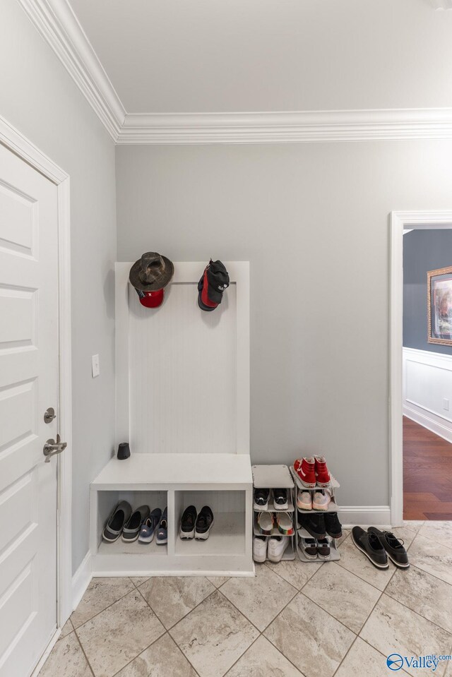 mudroom with tile patterned floors and ornamental molding