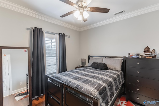 bedroom with ceiling fan, wood-type flooring, and ornamental molding