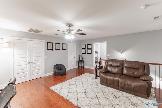 living room with ceiling fan and hardwood / wood-style flooring