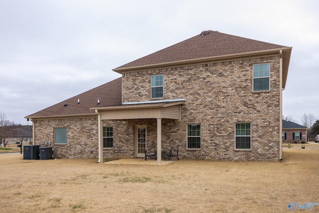 rear view of house with a patio and central AC unit